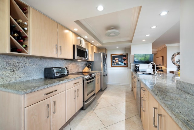 4000 Towerside Ter Unit 1005, Miami, FL 33138 - kitchen with light brown cabinetry, ornamental molding, appliances with stainless steel finishes, light stone counters, and backsplash