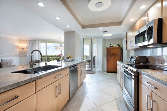 4000 Towerside Ter Unit 1005, Miami, FL 33138 - kitchen with light brown cabinetry, stainless steel appliances, light stone counters, ornamental molding, and a tray ceiling