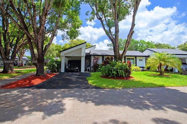 16041 Fairway Ter Unit 121, Weston, FL 33326 - view of front of house featuring asphalt driveway, a front lawn, and a garage