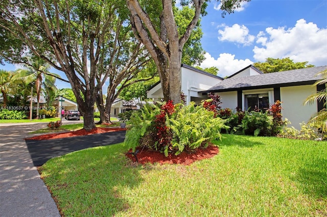 16041 Fairway Ter Unit 121, Weston, FL 33326 - view of side of home with stucco siding and a lawn