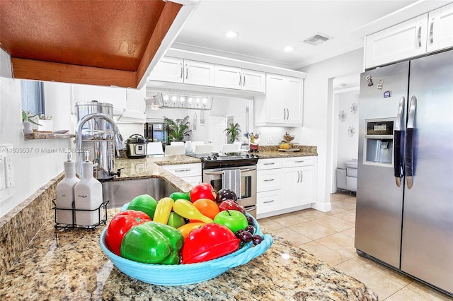 16041 Fairway Ter Unit 121, Weston, FL 33326 - kitchen with stainless steel appliances, white cabinets, light tile patterned flooring, light stone counters, and crown molding