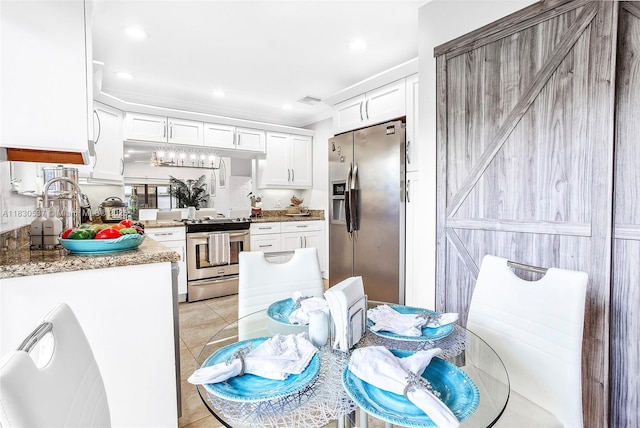 16041 Fairway Ter Unit 121, Weston, FL 33326 - kitchen with appliances with stainless steel finishes, white cabinets, light tile patterned flooring, and recessed lighting