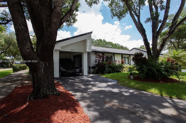 16041 Fairway Ter Unit 121, Weston, FL 33326 - view of front of home featuring driveway, stucco siding, and an attached carport