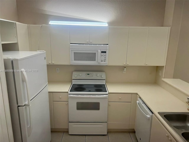 1666 SE 27th Ct Unit 208, Homestead, FL 33035 - kitchen featuring white appliances, light tile patterned flooring, light countertops, and white cabinets