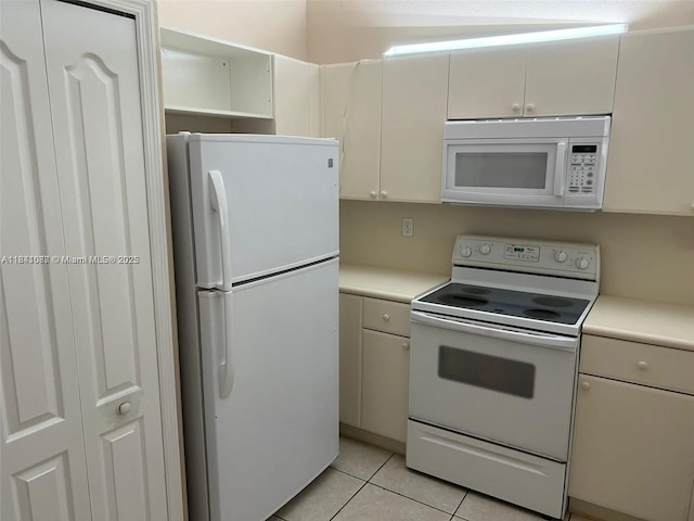 1666 SE 27th Ct Unit 208, Homestead, FL 33035 - kitchen featuring white appliances, light countertops, and light tile patterned floors