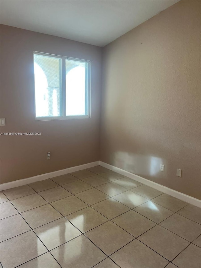 1666 SE 27th Ct Unit 208, Homestead, FL 33035 - unfurnished room with light tile patterned floors and baseboards
