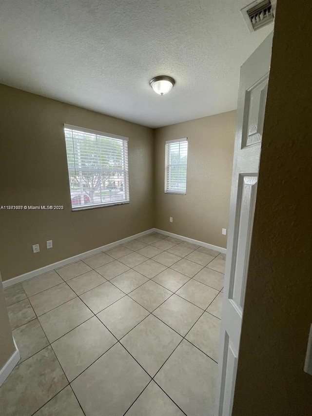 1666 SE 27th Ct Unit 208, Homestead, FL 33035 - unfurnished room with light tile patterned floors and a textured ceiling