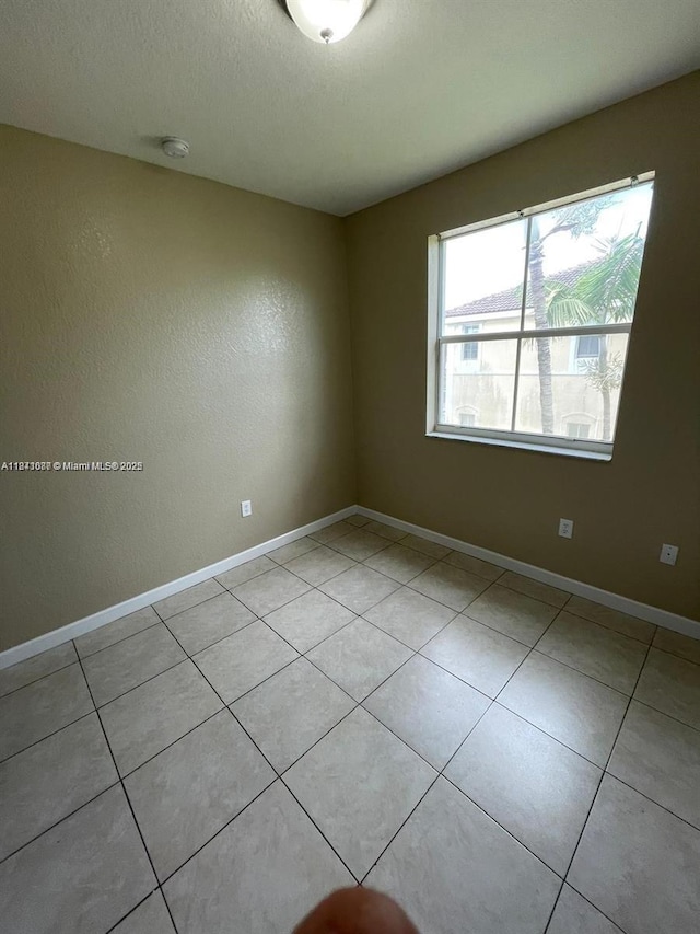 1666 SE 27th Ct Unit 208, Homestead, FL 33035 - spare room featuring light tile patterned floors and a textured ceiling