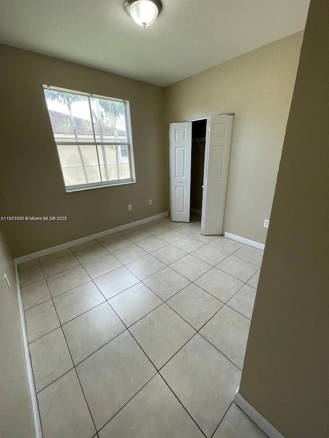1666 SE 27th Ct Unit 208, Homestead, FL 33035 - unfurnished bedroom featuring light tile patterned flooring and a closet