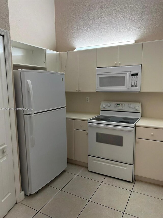 1666 SE 27th Ct Unit 208, Homestead, FL 33035 - kitchen with white appliances, light countertops, and light tile patterned floors
