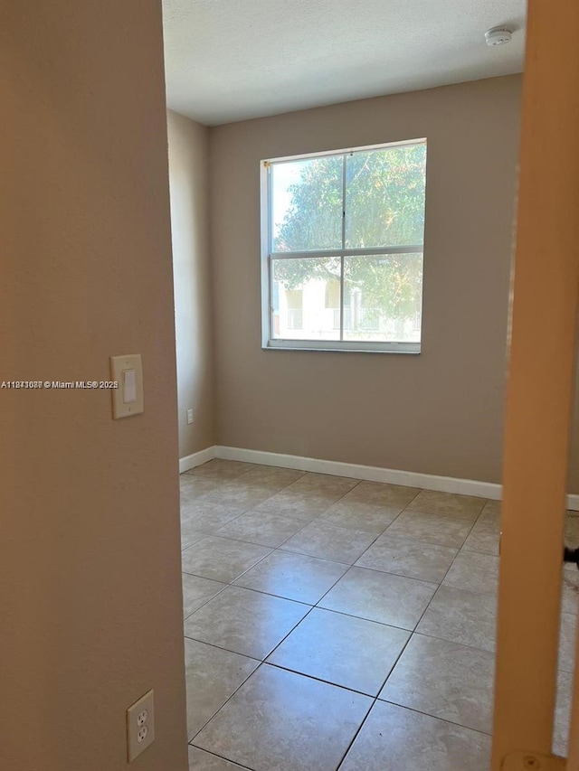 1666 SE 27th Ct Unit 208, Homestead, FL 33035 - unfurnished room with light tile patterned floors and baseboards
