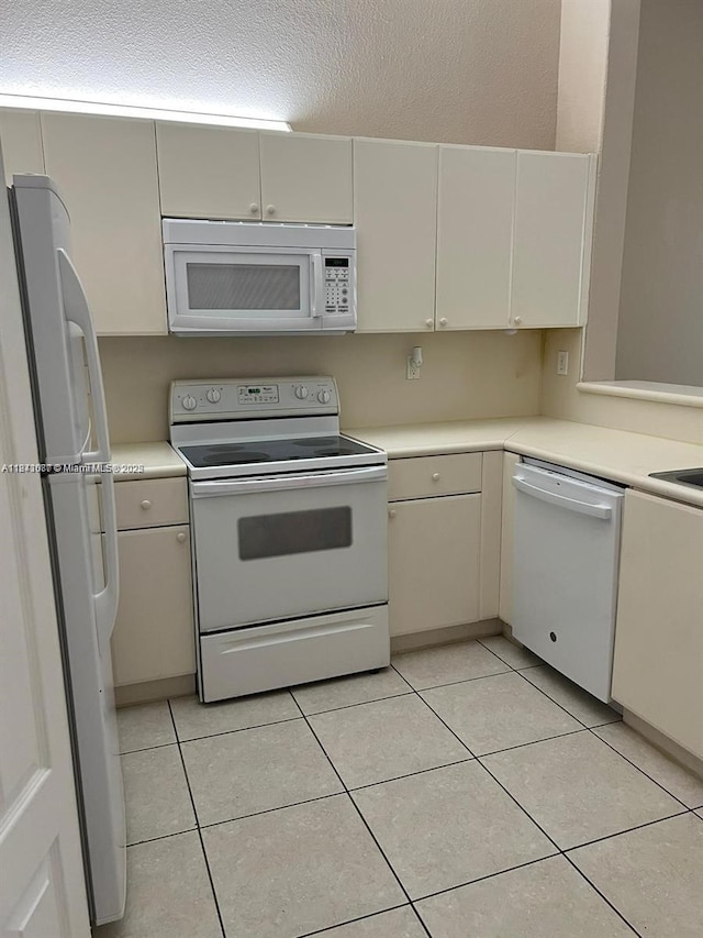 1666 SE 27th Ct Unit 208, Homestead, FL 33035 - kitchen featuring white appliances, light countertops, and light tile patterned flooring