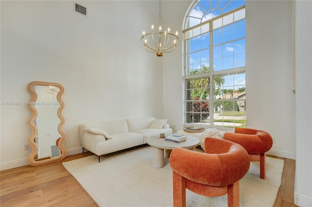 1503 NW 178th Ln, Pembroke Pines, FL 33029 - living room with wood finished floors, a towering ceiling, and a chandelier
