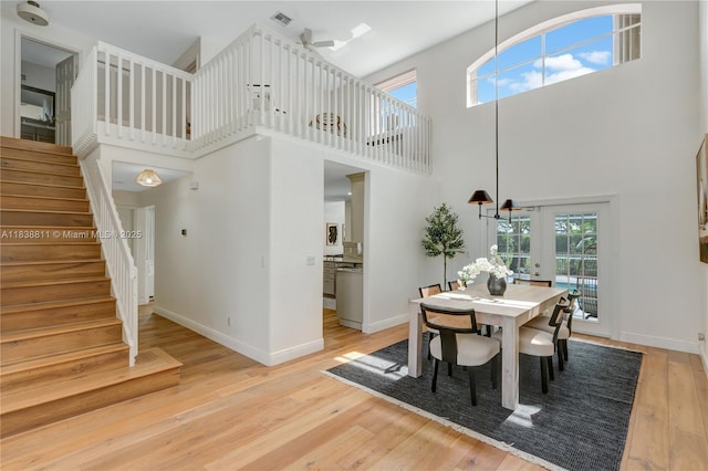 1503 NW 178th Ln, Pembroke Pines, FL 33029 - dining space featuring a high ceiling, stairs, and light wood finished floors