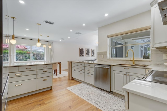 1503 NW 178th Ln, Pembroke Pines, FL 33029 - kitchen featuring stainless steel dishwasher, light wood-type flooring, pendant lighting, decorative backsplash, and white cabinets