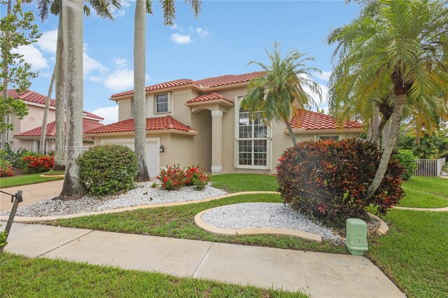 1503 NW 178th Ln, Pembroke Pines, FL 33029 - mediterranean / spanish home featuring stucco siding, a tile roof, a front lawn, and a garage