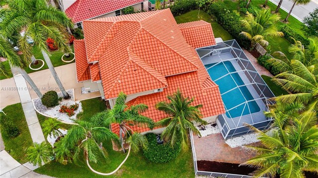1503 NW 178th Ln, Pembroke Pines, FL 33029 - rear view of house with a tiled roof, stucco siding, an outdoor pool, glass enclosure, and a patio