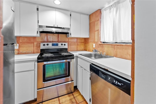 2924 Day Ave Unit N211, Miami, FL 33133 - kitchen with appliances with stainless steel finishes, light countertops, under cabinet range hood, white cabinets, and recessed lighting