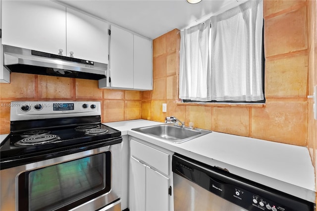 2924 Day Ave Unit N211, Miami, FL 33133 - kitchen with stainless steel appliances, under cabinet range hood, light countertops, white cabinets, and backsplash