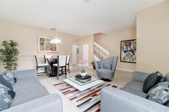 14053 SW 49th St Unit 7, Miramar, FL 33027 - living room featuring light tile patterned floors, a chandelier, stairs, and arched walkways