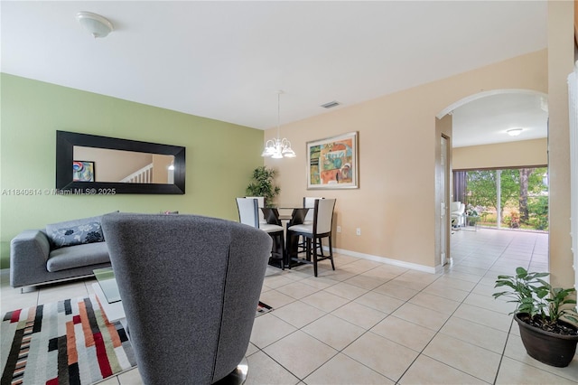 14053 SW 49th St Unit 7, Miramar, FL 33027 - living room with arched walkways, light tile patterned flooring, and a chandelier