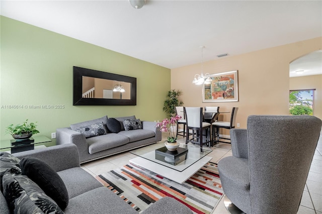 14053 SW 49th St Unit 7, Miramar, FL 33027 - living area with arched walkways, a chandelier, and tile patterned floors