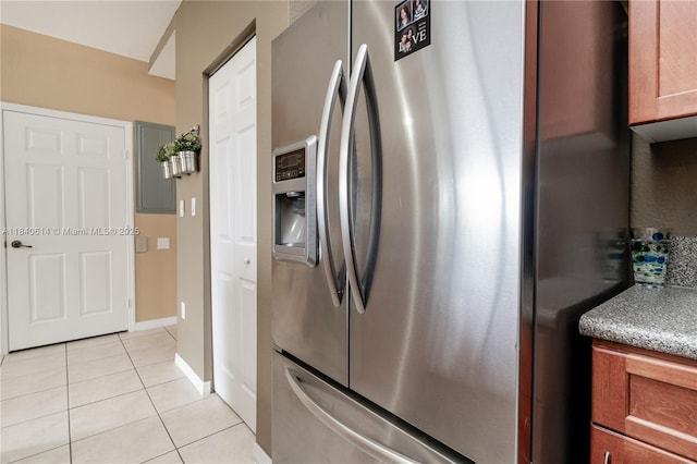 14053 SW 49th St Unit 7, Miramar, FL 33027 - kitchen featuring stainless steel refrigerator with ice dispenser, light tile patterned floors, electric panel, and brown cabinetry