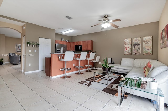 14053 SW 49th St Unit 7, Miramar, FL 33027 - living room with arched walkways, a ceiling fan, and light tile patterned floors