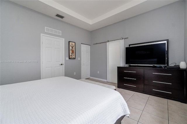14053 SW 49th St Unit 7, Miramar, FL 33027 - bedroom with a barn door and light tile patterned flooring