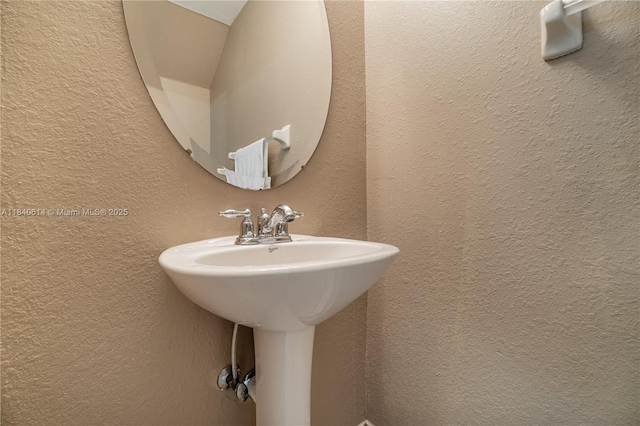 14053 SW 49th St Unit 7, Miramar, FL 33027 - bathroom featuring a textured wall and a sink