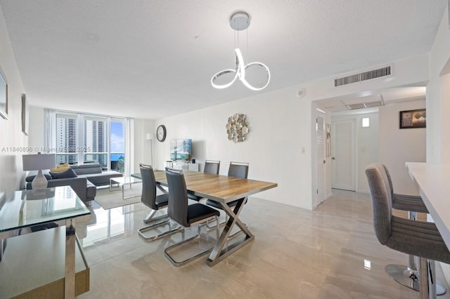 19370 Collins Ave Unit 1425, Sunny Isles Beach, FL 33160 - dining space featuring a chandelier, expansive windows, and light marble finish flooring