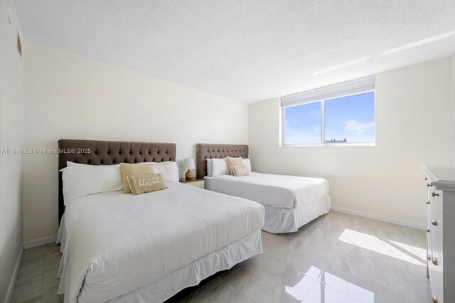 19370 Collins Ave Unit 1425, Sunny Isles Beach, FL 33160 - bedroom with a textured ceiling and baseboards