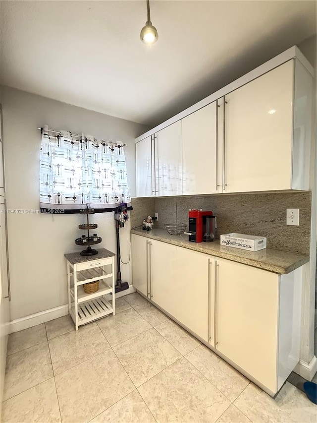 11 Olive Dr Unit E, Hialeah, FL 33010 - kitchen featuring light tile patterned flooring, decorative backsplash, and white cabinetry