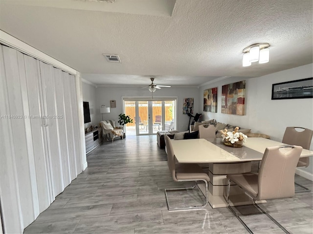 11 Olive Dr Unit E, Hialeah, FL 33010 - dining space featuring a textured ceiling, ceiling fan, and wood finished floors
