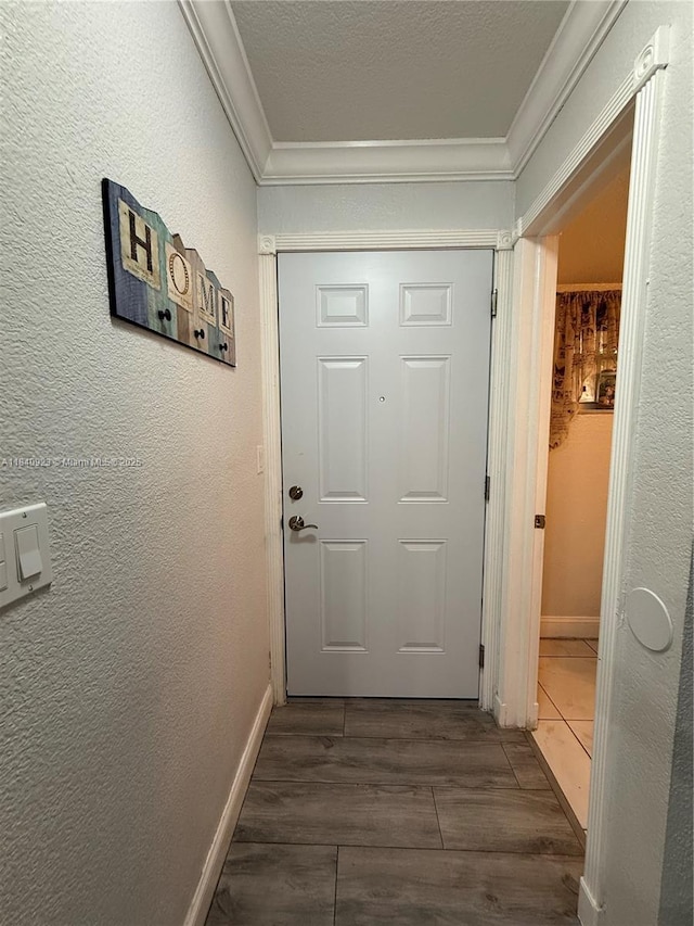 11 Olive Dr Unit E, Hialeah, FL 33010 - doorway to outside featuring crown molding, dark wood finished floors, and a textured wall