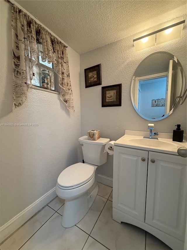 11 Olive Dr Unit E, Hialeah, FL 33010 - half bath with a textured ceiling, vanity, and tile patterned flooring