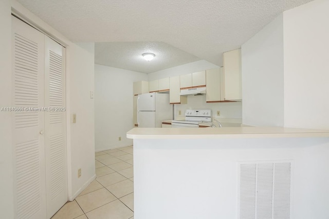 9033 Wiles Rd Unit 304, Coral Springs, FL 33067 - kitchen featuring a textured ceiling, white appliances, light countertops, a peninsula, and light tile patterned flooring