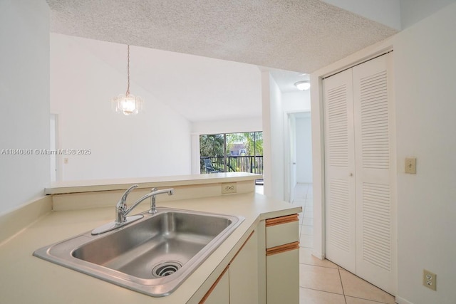 9033 Wiles Rd Unit 304, Coral Springs, FL 33067 - kitchen with light tile patterned floors, pendant lighting, light countertops, and a textured ceiling