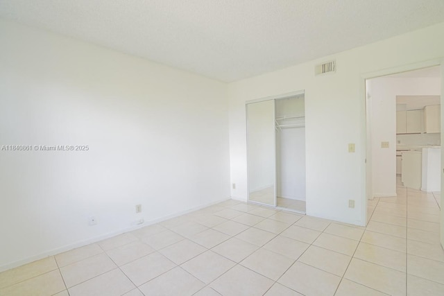 9033 Wiles Rd Unit 304, Coral Springs, FL 33067 - unfurnished bedroom with light tile patterned flooring and a closet