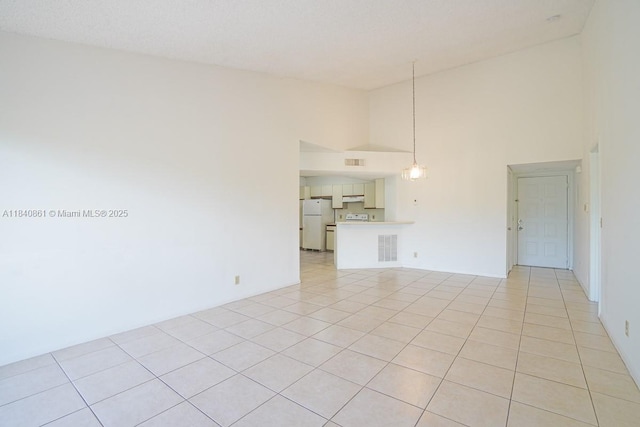9033 Wiles Rd Unit 304, Coral Springs, FL 33067 - unfurnished living room with high vaulted ceiling and light tile patterned floors