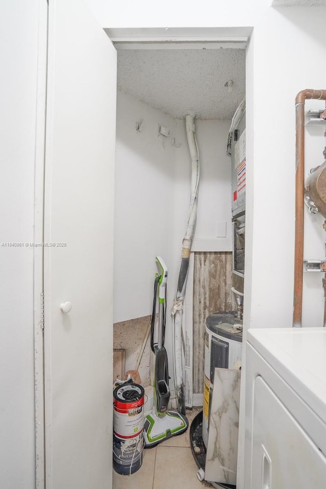 9033 Wiles Rd Unit 304, Coral Springs, FL 33067 - washroom with washer / clothes dryer and light tile patterned flooring