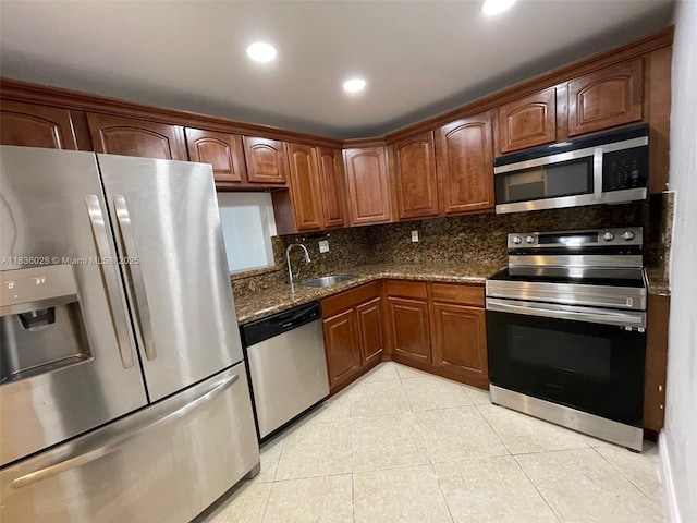 9143 SW 77th Ave Unit B105, Miami, FL 33156 - kitchen featuring stainless steel appliances, decorative backsplash, light tile patterned floors, dark stone counters, and recessed lighting