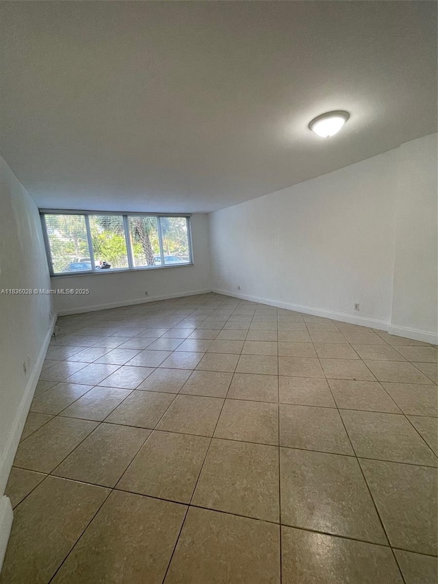 9143 SW 77th Ave Unit B105, Miami, FL 33156 - tiled spare room featuring baseboards