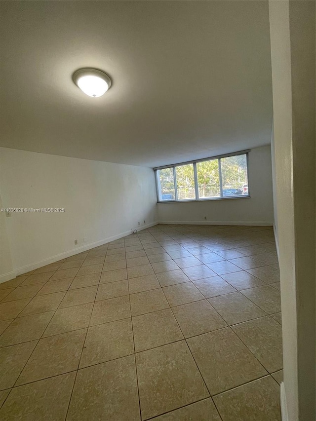 9143 SW 77th Ave Unit B105, Miami, FL 33156 - tiled spare room featuring baseboards