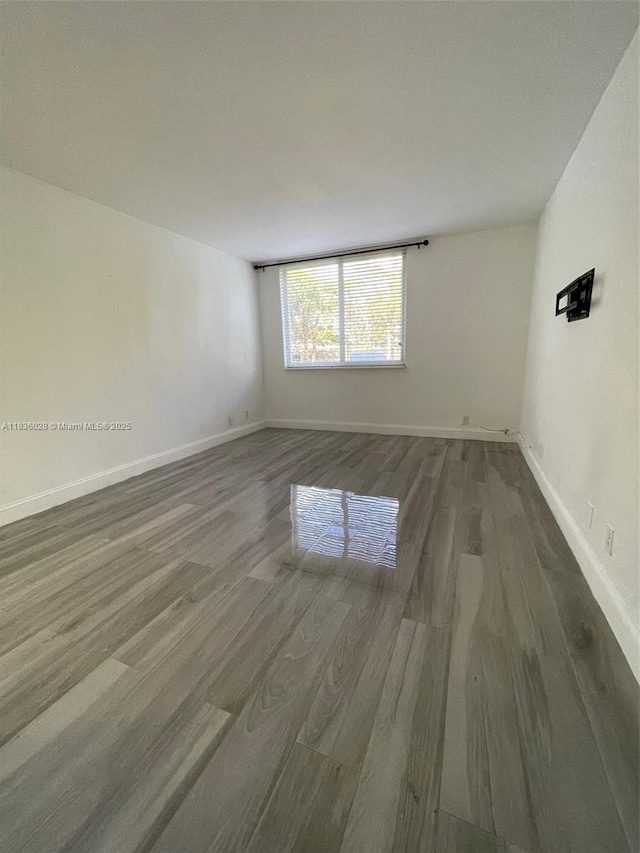 9143 SW 77th Ave Unit B105, Miami, FL 33156 - spare room featuring wood finished floors and baseboards