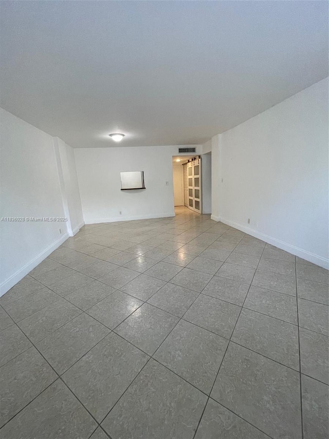 9143 SW 77th Ave Unit B105, Miami, FL 33156 - tiled spare room featuring baseboards