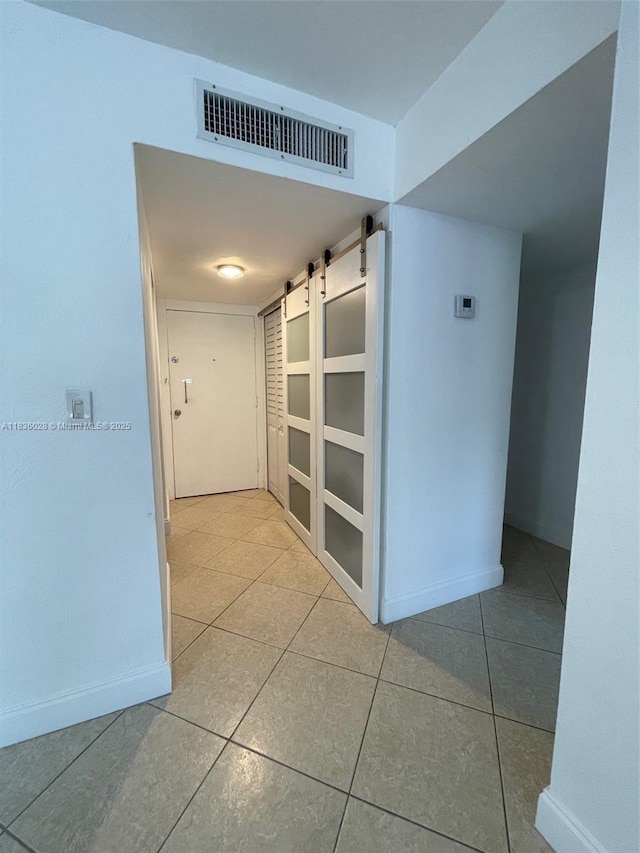 9143 SW 77th Ave Unit B105, Miami, FL 33156 - hallway with a barn door and tile patterned floors