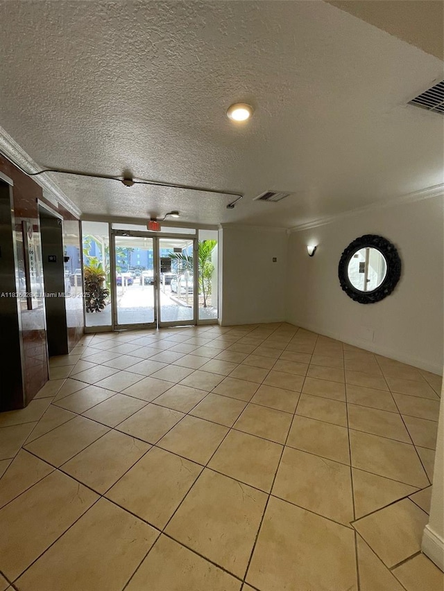 9143 SW 77th Ave Unit B105, Miami, FL 33156 - unfurnished room with light tile patterned floors, a textured ceiling, floor to ceiling windows, and elevator