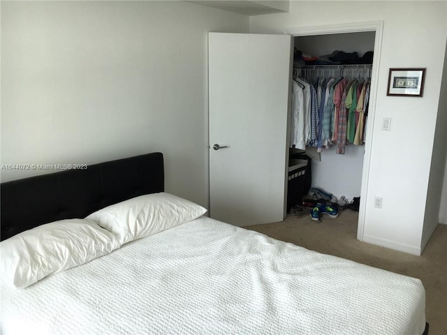 bedroom with carpet and a closet