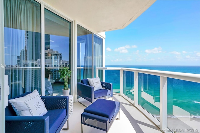 balcony featuring a water view and outdoor lounge area